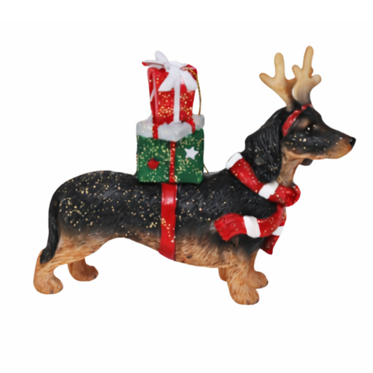 Dachshund Christmas tree decoration with reindeer antlers and red bow, carrying a stack of glittery wrapped gifts