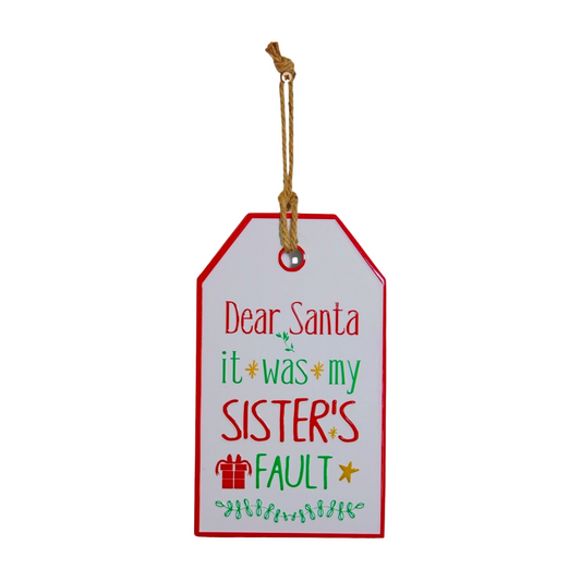 Rectangular Christmas sign with red and green text reading “Dear Santa it was my sister’s fault” and jute string for hanging