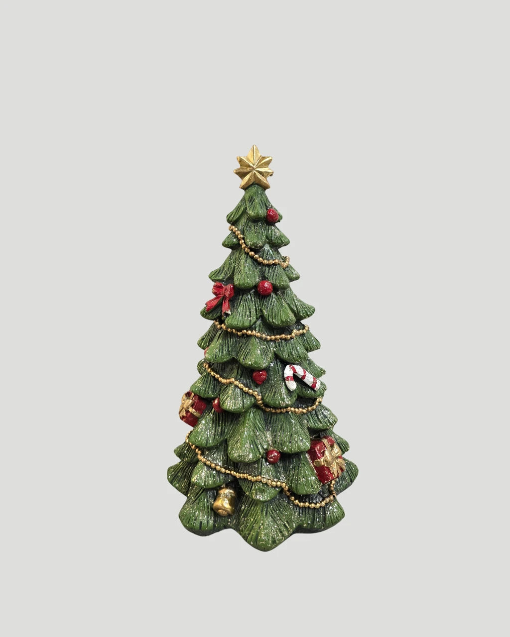Decorated Christmas tree figure with star topper, styled with festive lights and gift box