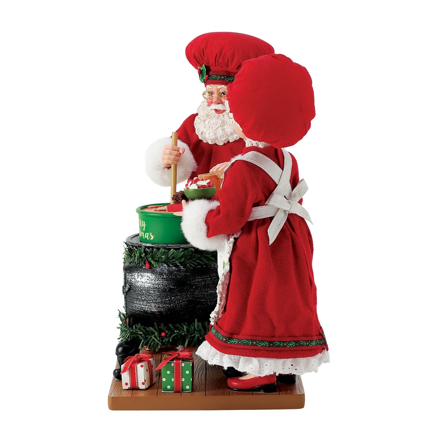 Side view of Santa and Mrs. Claus chef figurines; Santa stirs a "Merry Christmas" pot while Mrs. Claus holds a tray of drinks and treats