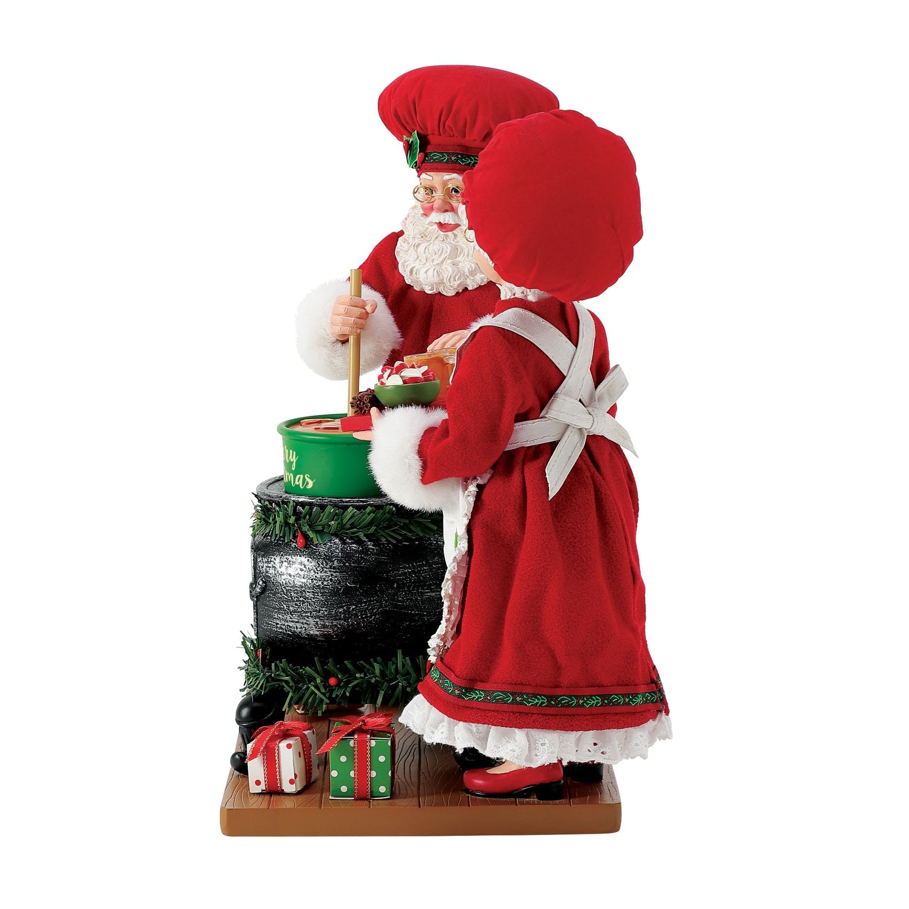 Side view of Santa and Mrs. Claus chef figurines; Santa stirs a "Merry Christmas" pot while Mrs. Claus holds a tray of drinks and treats