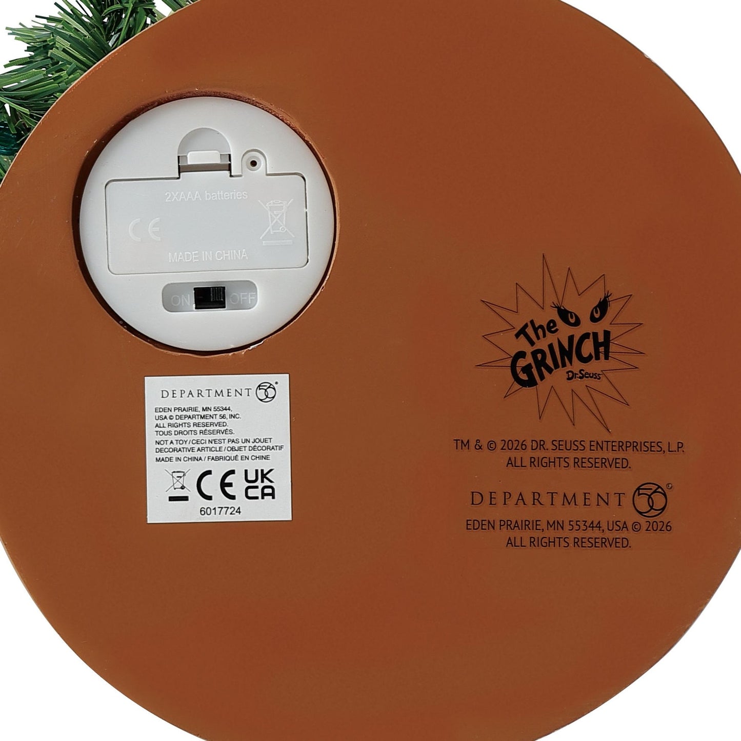 Underside of the base showing battery compartment, on/off switch, Department 56 label, and The Grinch Dr. Seuss licensing text 