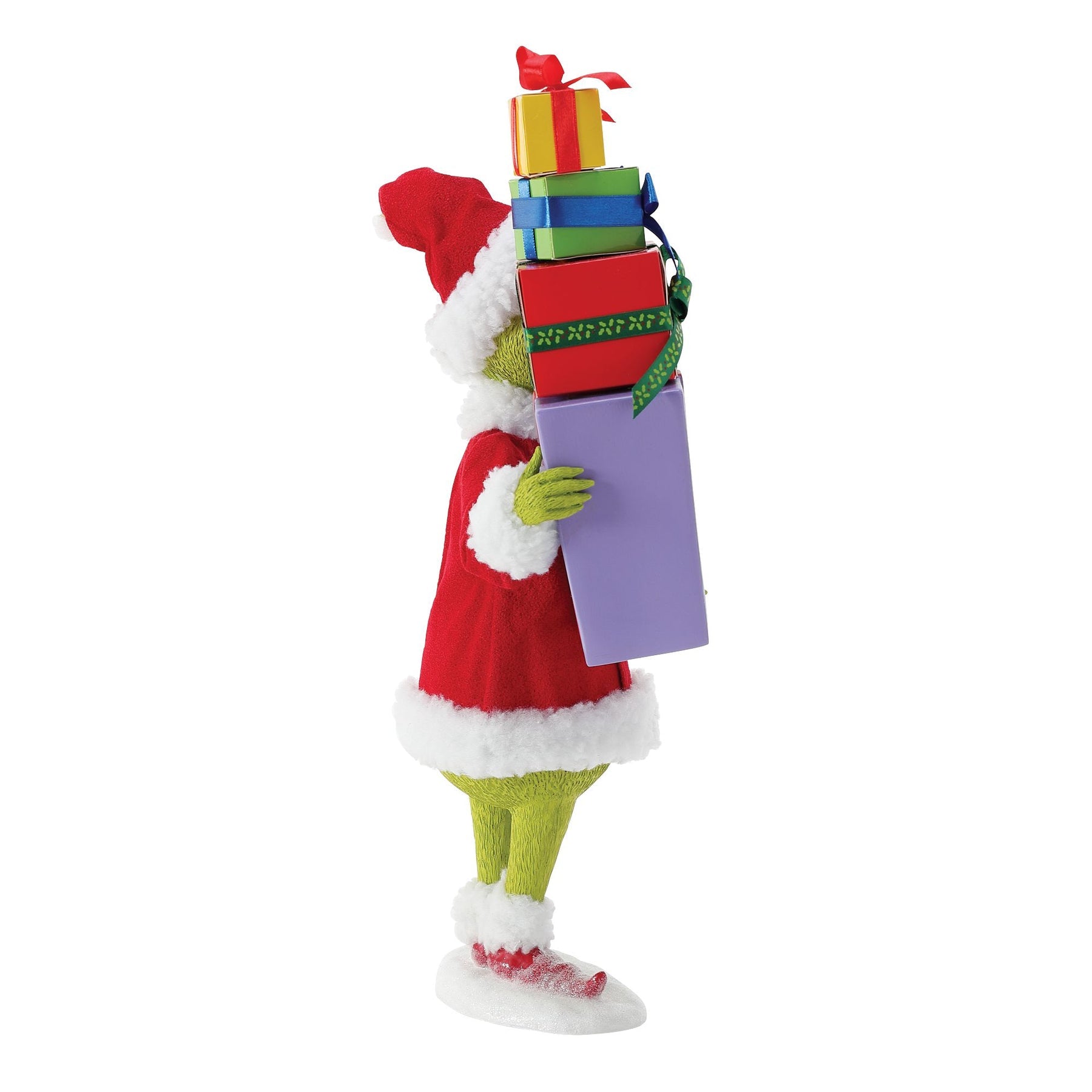 Side view of Grinch figurine in Santa suit carrying a tall stack of colourful wrapped gifts, face obscured by the pile