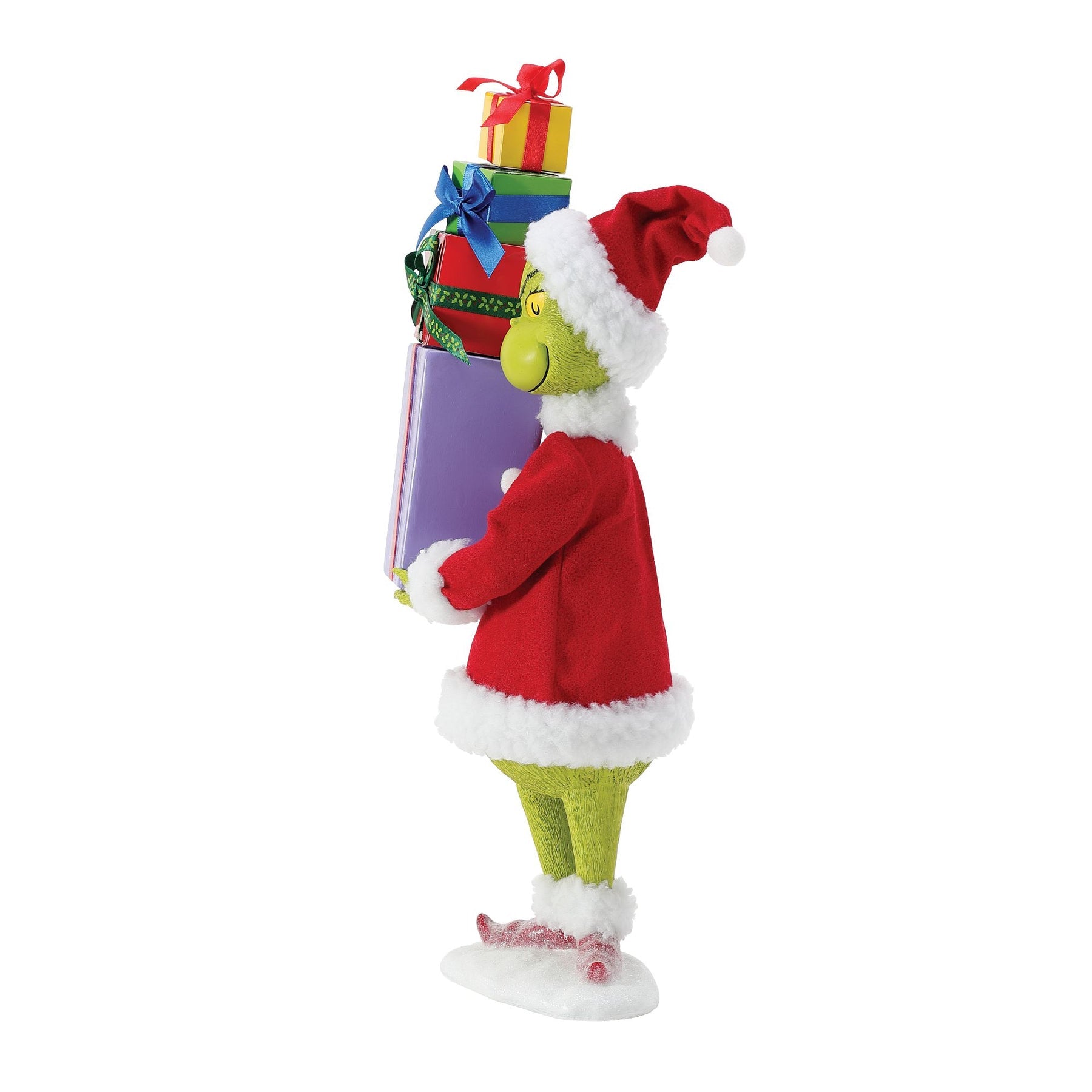 Three-quarter view of Grinch figurine in red Santa suit carrying a stack of four colourful wrapped gifts on a snowy base