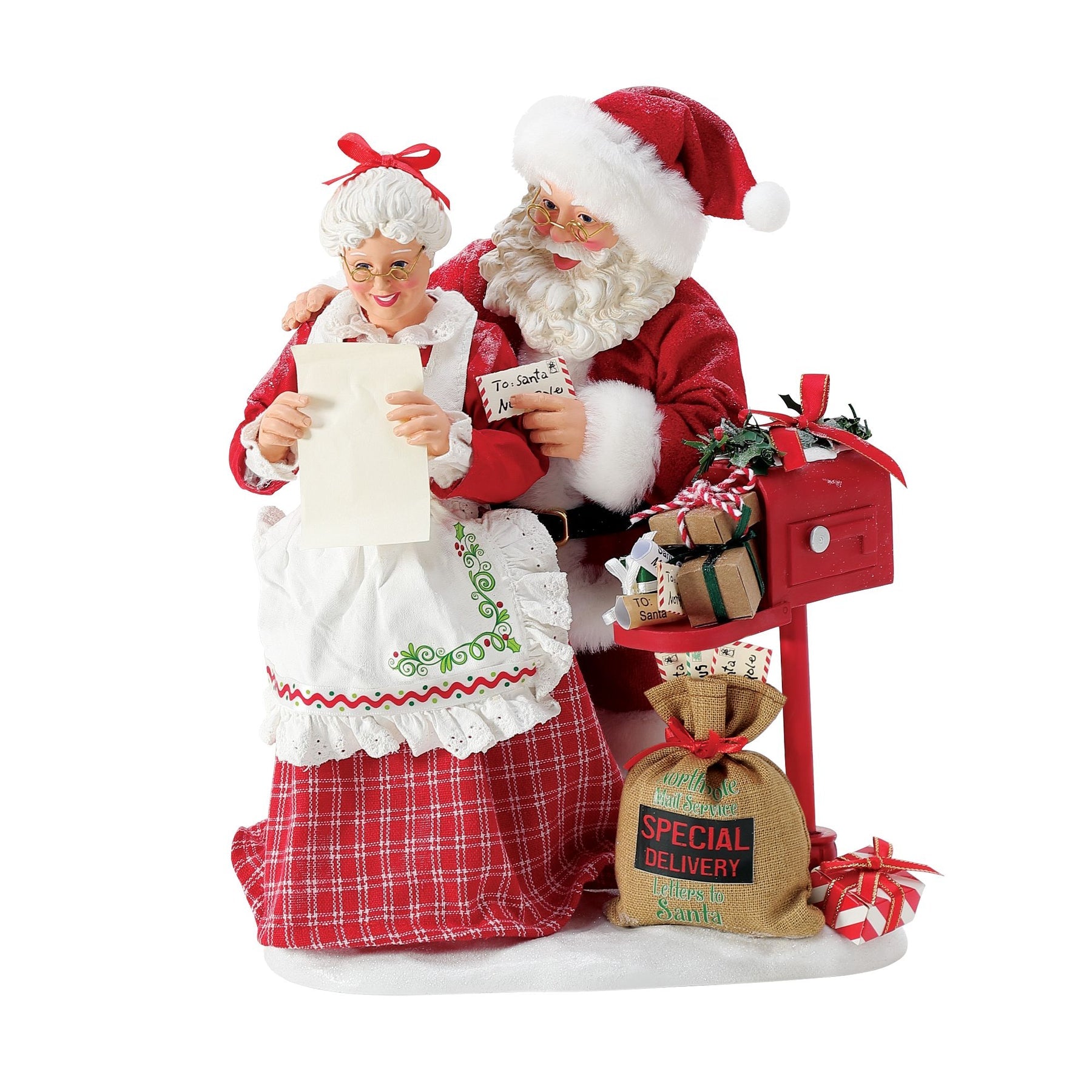 Santa and Mrs. Claus figurines reading a letter together at a red mailbox with a "North Pole Special Delivery – Letters to Santa" sack at their feet 