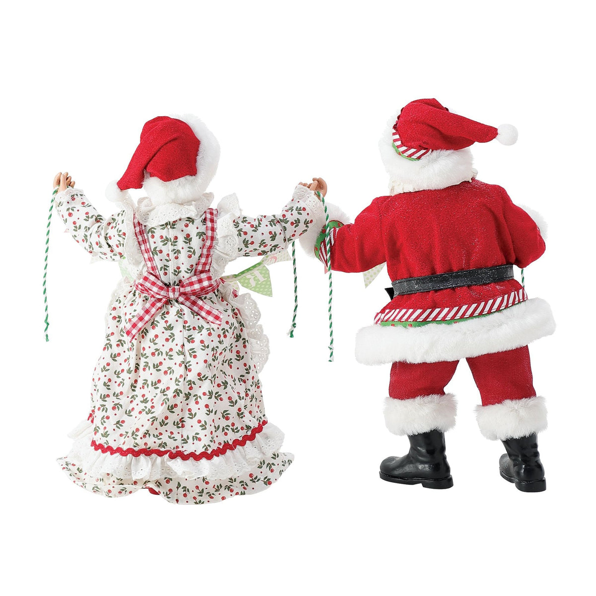 Rear view of Santa and Mrs. Claus figurines holding a "Merry Christmas" bunting banner between them, Mrs. Claus in a holly-print dress
