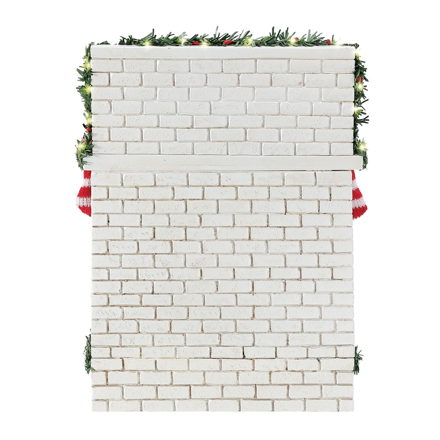 Rear view of the white brick fireplace base showing garland trim with small lights and two red and white striped stockings at the sides