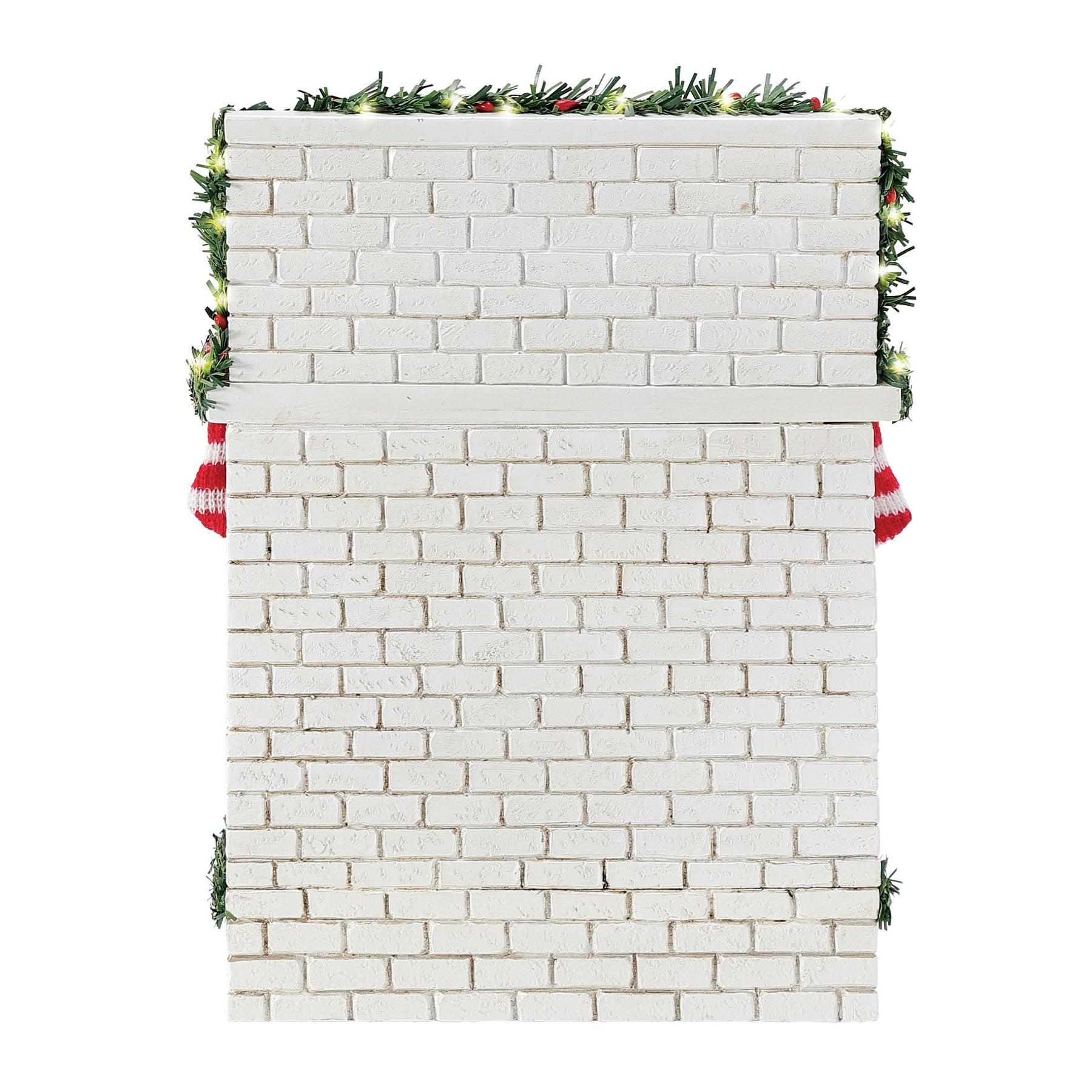 Rear view of the white brick fireplace base showing garland trim with small lights and two red and white striped stockings at the sides