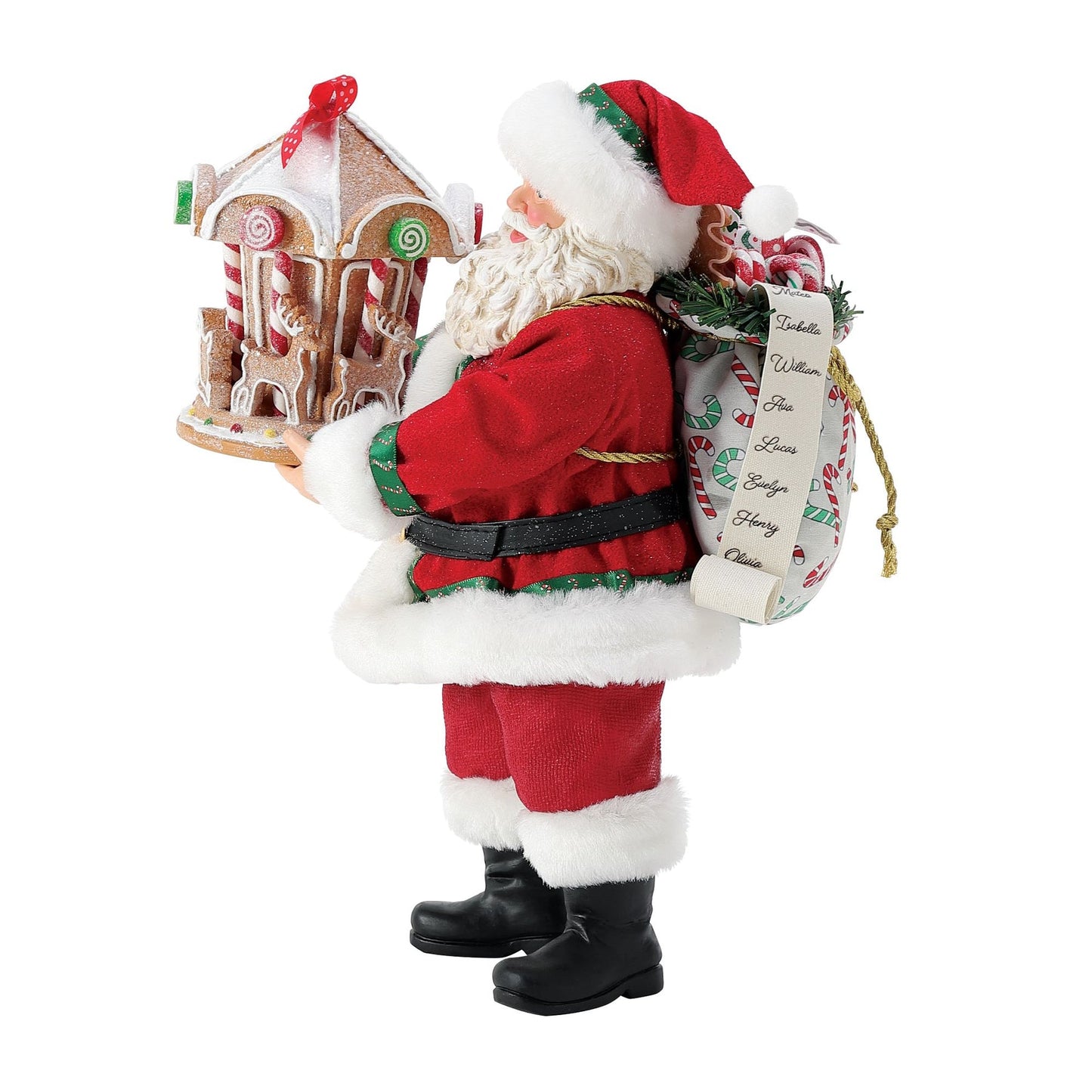 Santa figurine in red suit holding a detailed gingerbread carousel with lollipop decorations and red ribbon bow, naughty-or-nice list at side 