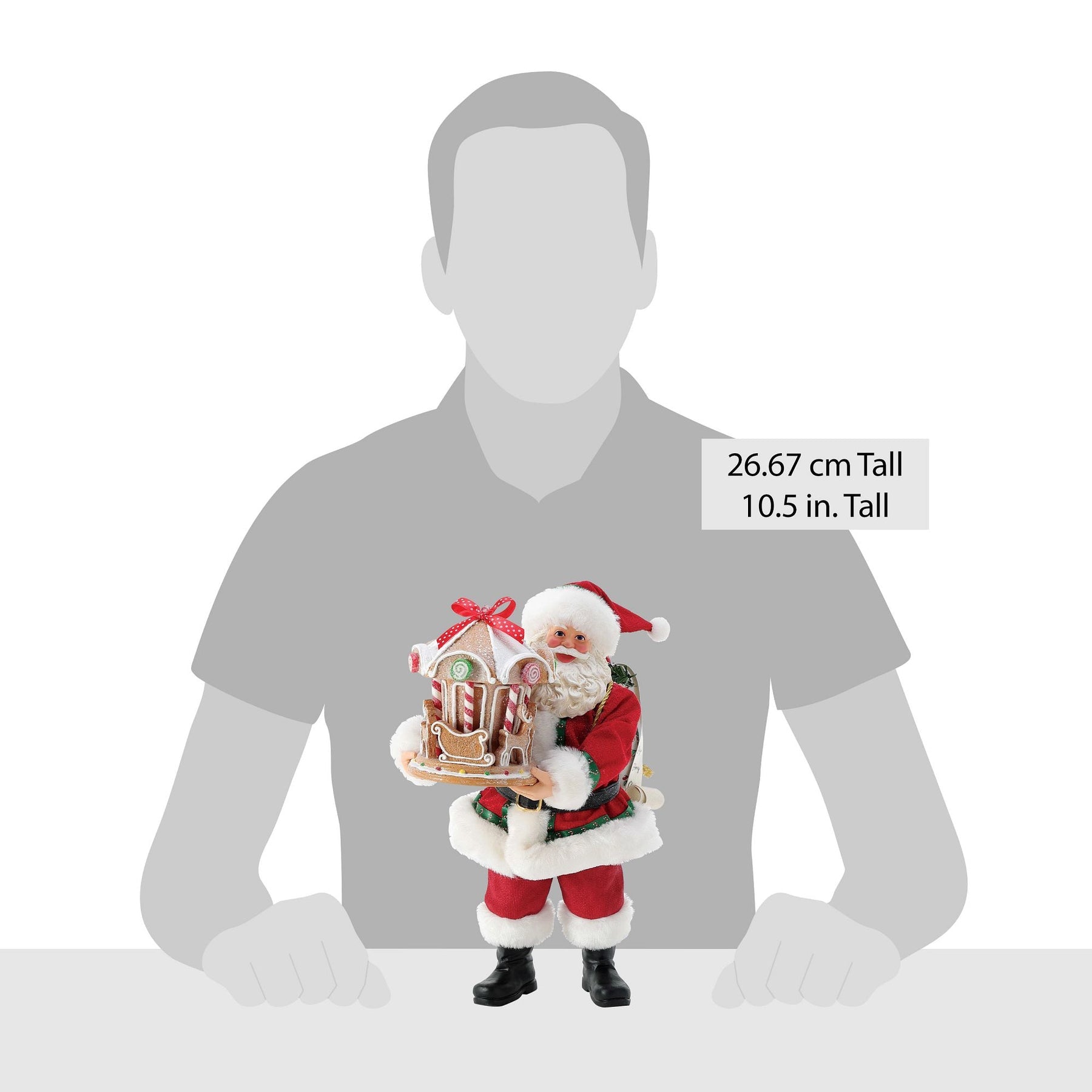 Santa figurine holding gingerbread carousel shown against a human silhouette for scale, 26.67 cm / 10.5 inches tall