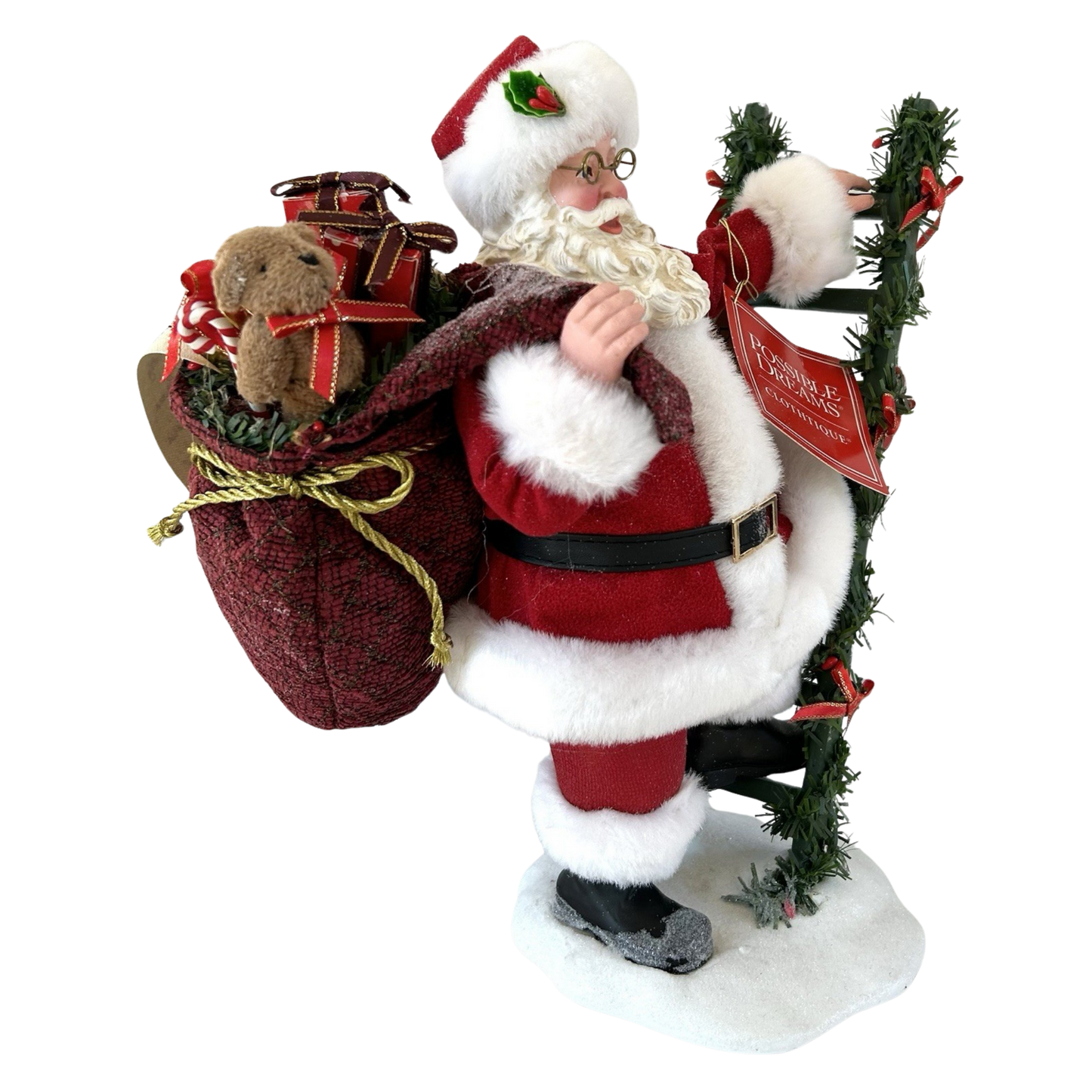 Front view of a Possible Dreams Clothtique Santa figure with gift sack and garland ladder, Possible Dreams branded tag visible