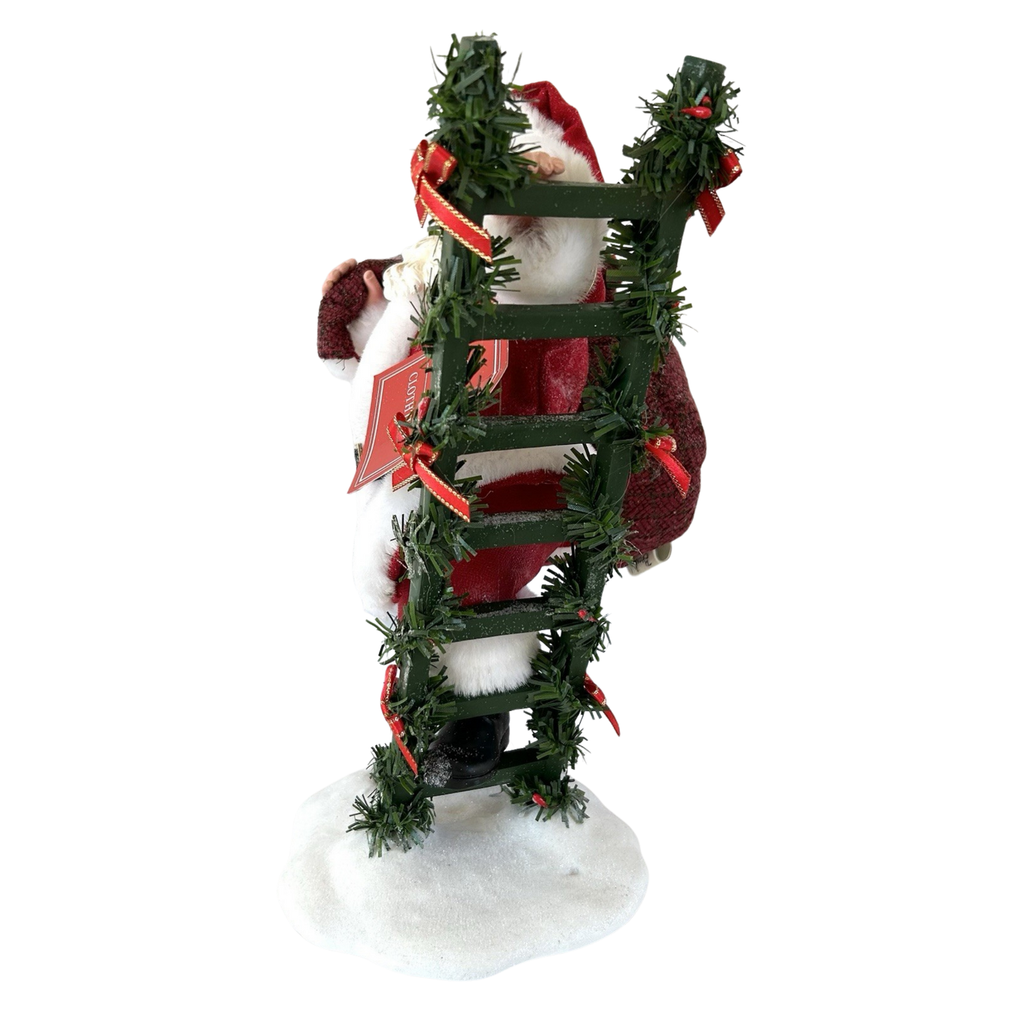 Side view of a Santa figure behind a garland and red bow-trimmed green ladder, carrying a large burgundy gift sack