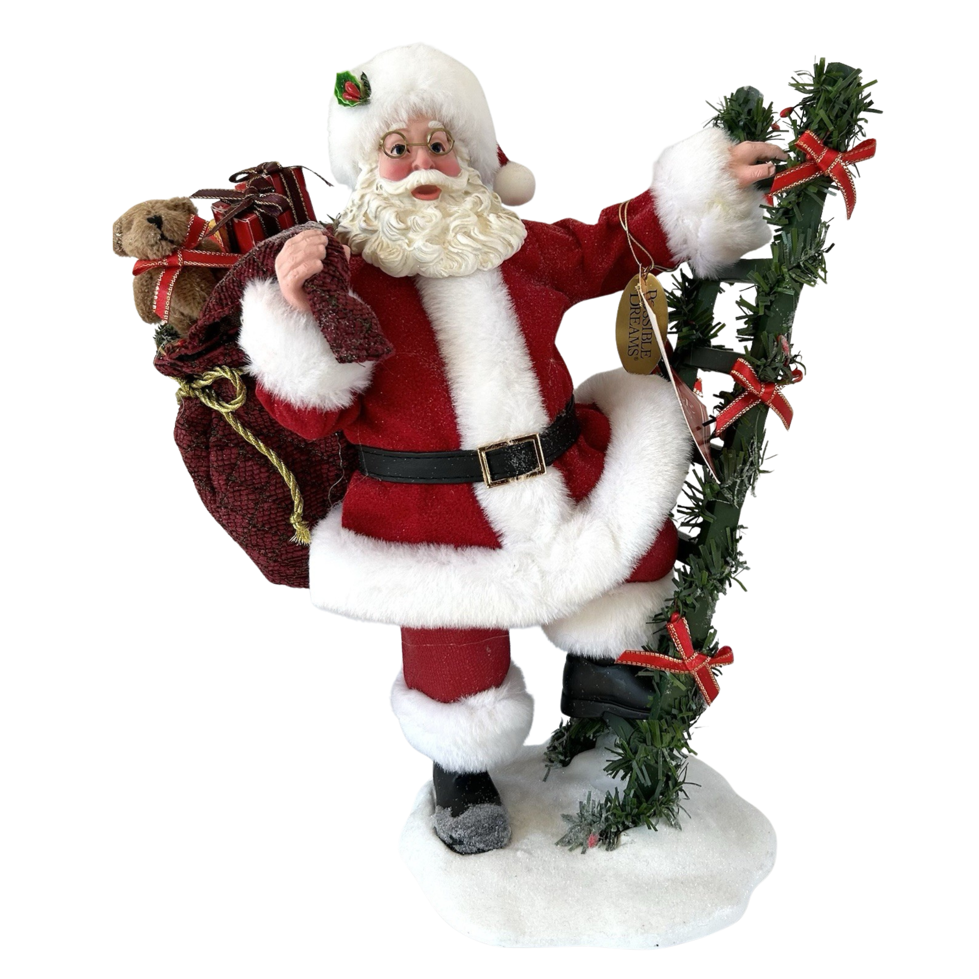 Three-quarter front view of a Possible Dreams Clothtique Santa figure with gift sack, teddy bear, and garland ladder on a snow base