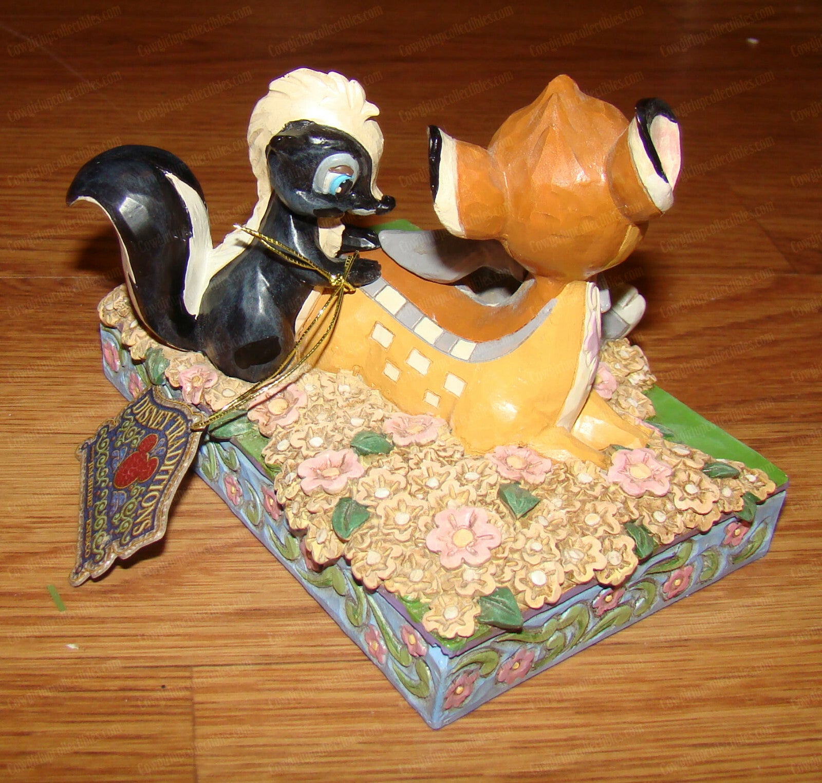 Disney Traditions figurine of Bambi, Thumper and Flower surrounded by painted flowers on a decorative base
