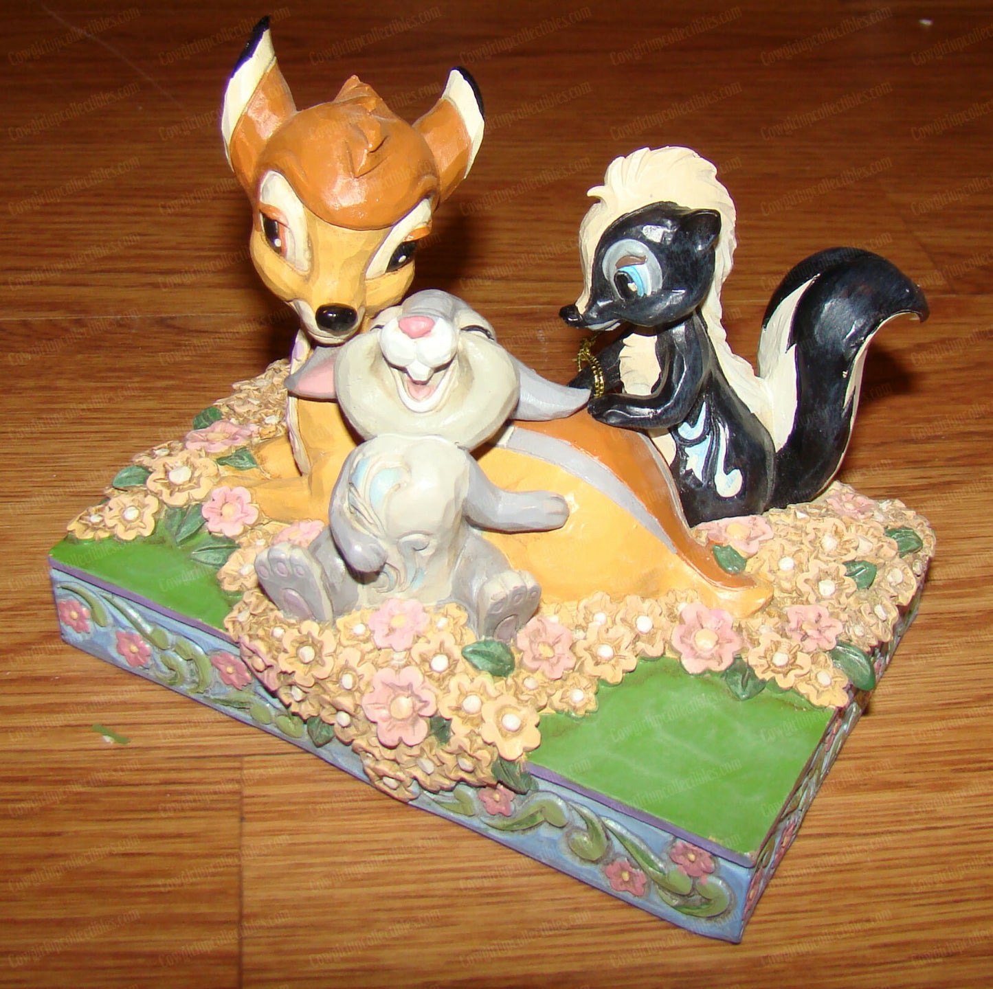 Disney Traditions figurine of Bambi, Thumper and Flower surrounded by painted flowers on a decorative base