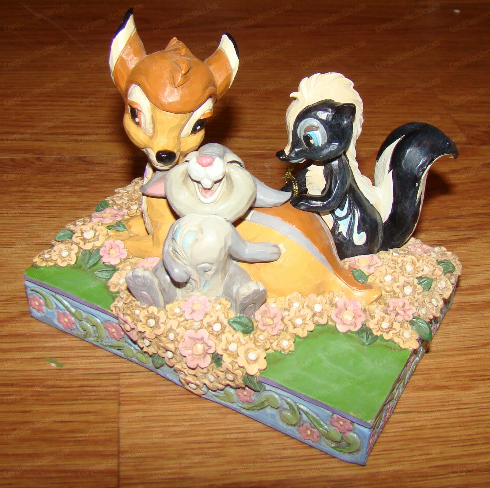 Disney Traditions figurine of Bambi, Thumper and Flower surrounded by painted flowers on a decorative base