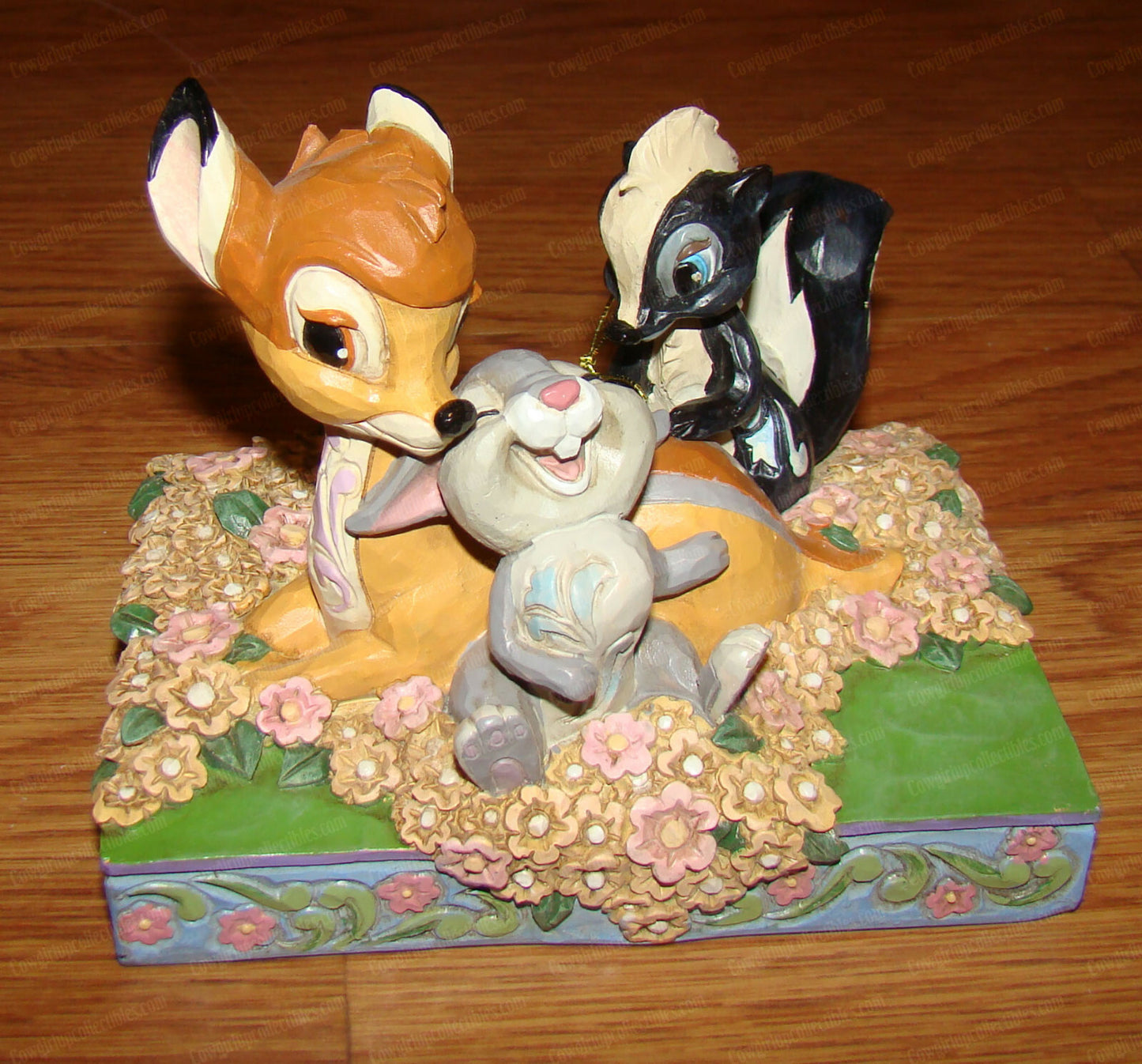 Disney Traditions figurine of Bambi, Thumper and Flower surrounded by painted flowers on a decorative base