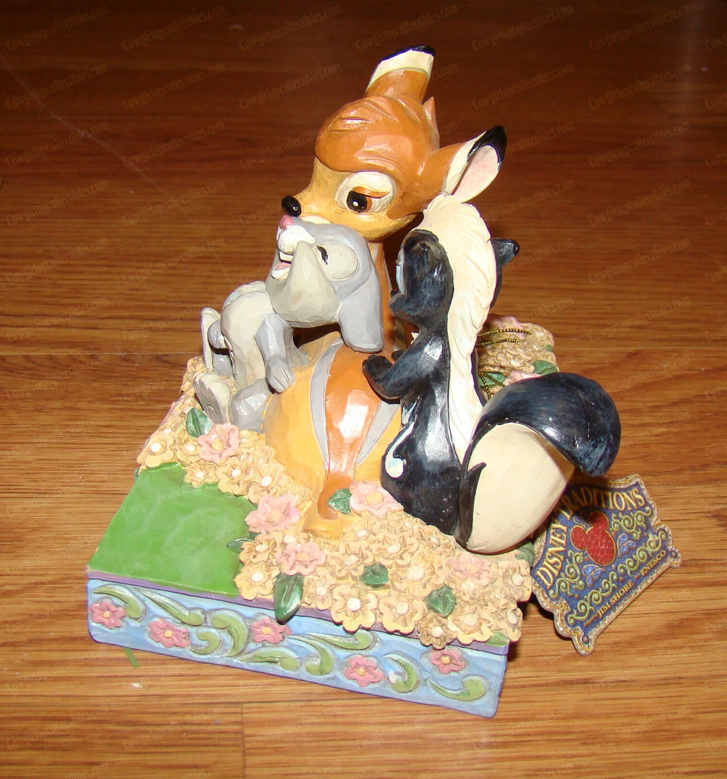 Disney Traditions figurine of Bambi, Thumper and Flower surrounded by painted flowers on a decorative base