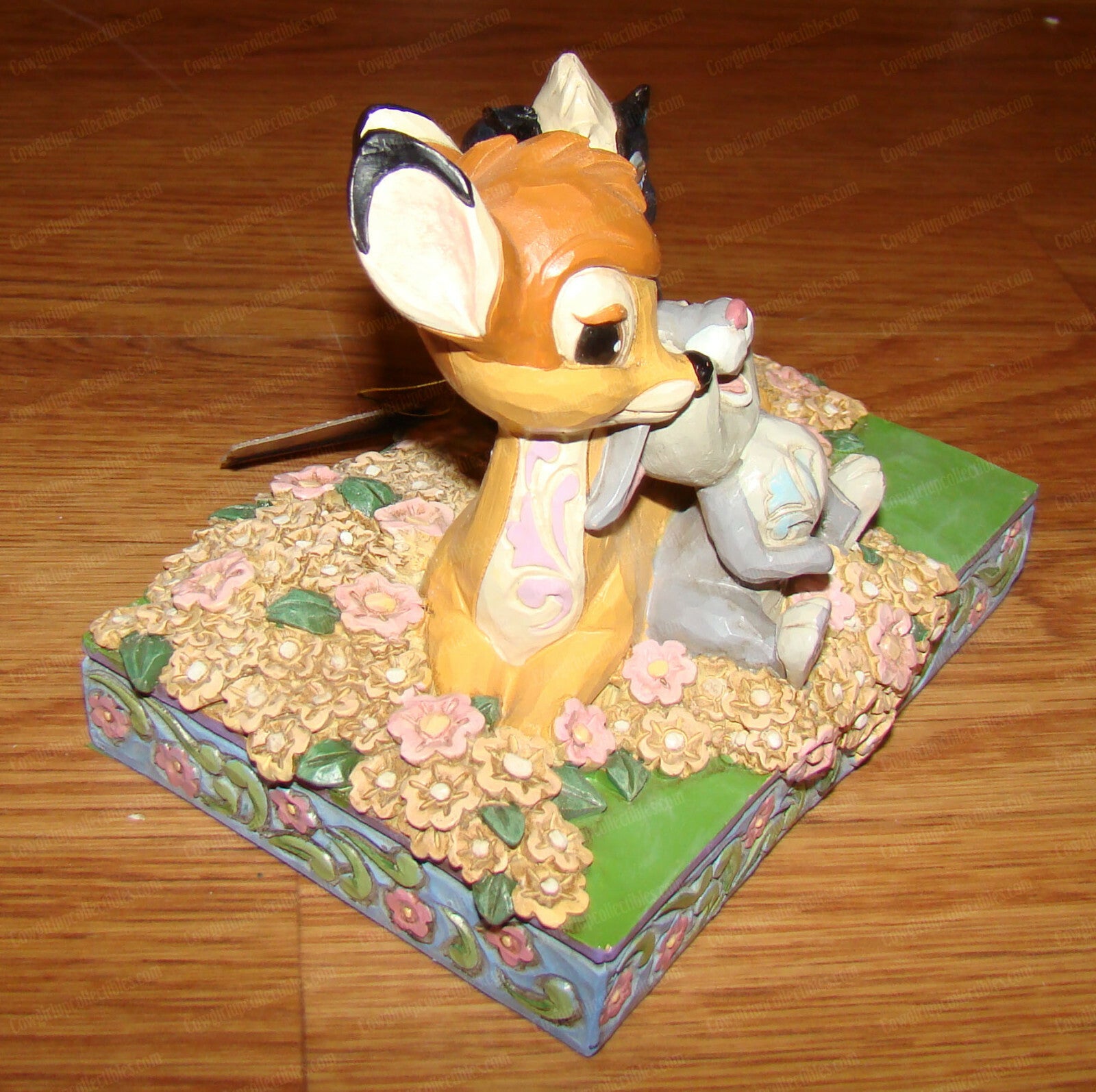 Disney Traditions figurine of Bambi, Thumper and Flower surrounded by painted flowers on a decorative base