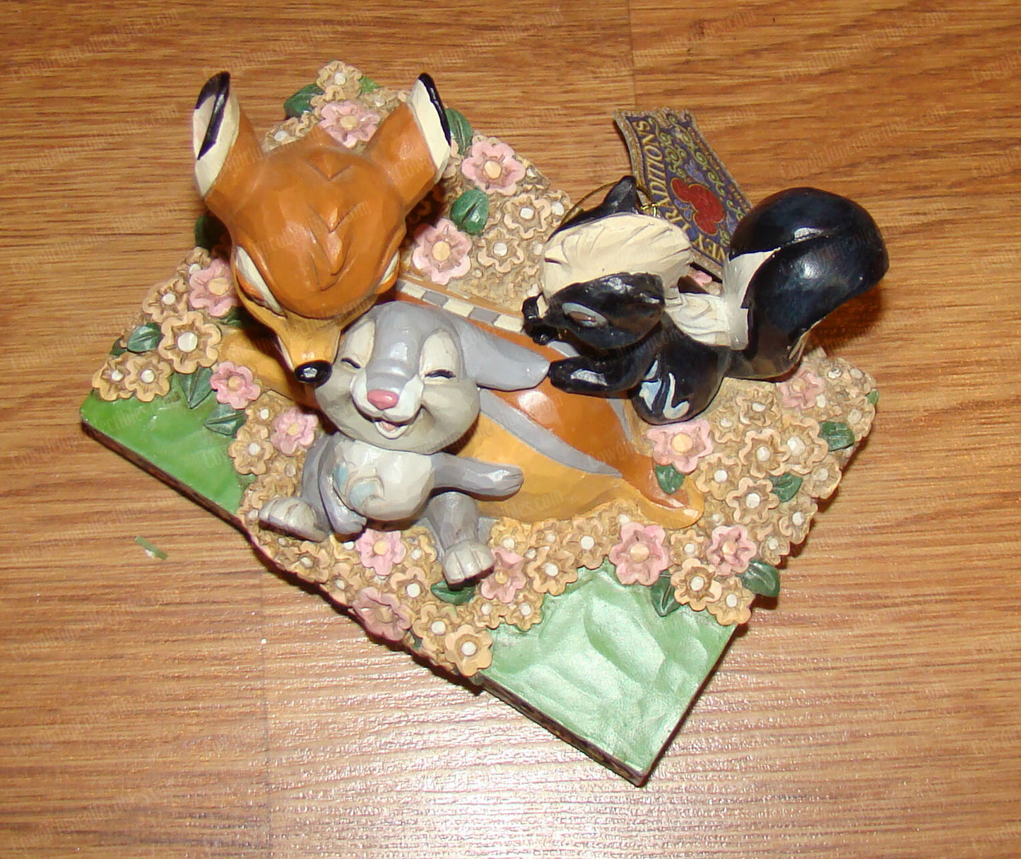 Disney Traditions figurine of Bambi, Thumper and Flower surrounded by painted flowers on a decorative base