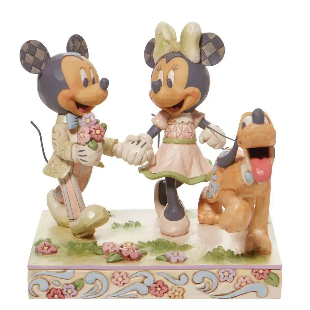 Disney Traditions figurine of Mickey and Minnie Mouse holding hands with Pluto, in pastel spring colours on a floral base