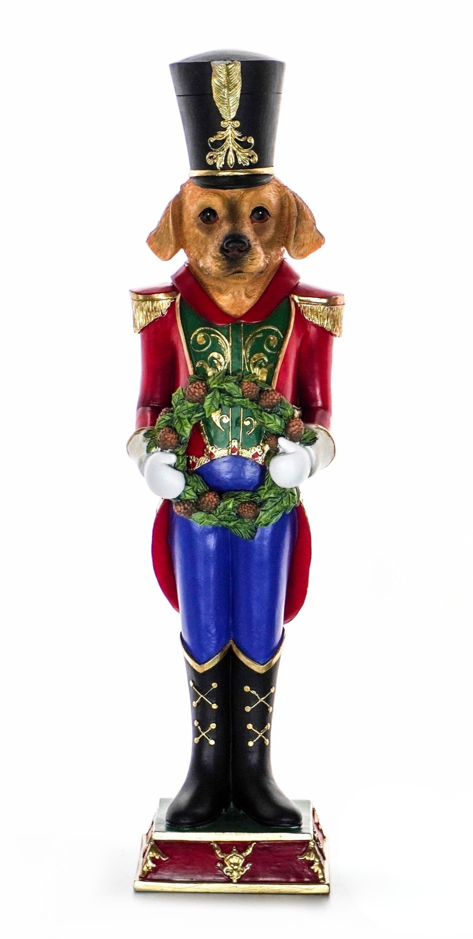 Dog nutcracker figurine in red, green, and blue uniform holding a Christmas wreath