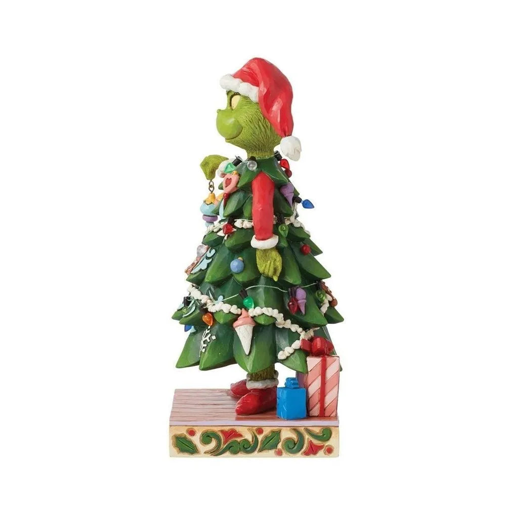 Opposite side view of a Grinch Christmas tree figurine adorned with multicolour baubles, garland, and wrapped gifts at the base