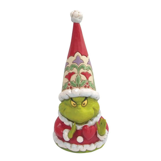 Front view of a Grinch gnome figurine with a scowling expression, holding a small heart, tall patterned Santa hat above