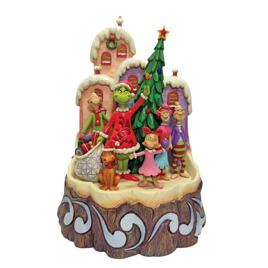Front view of Grinch Who-ville scene figurine, Grinch with Cindy Lou, Max and Who characters, Christmas tree, pastel snow-capped buildings
