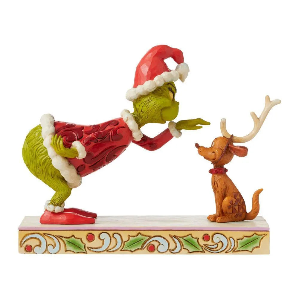 Grinch and Max figurine, Grinch in red folk art Santa suit leaning toward Max wearing reindeer antlers, holly patterned base