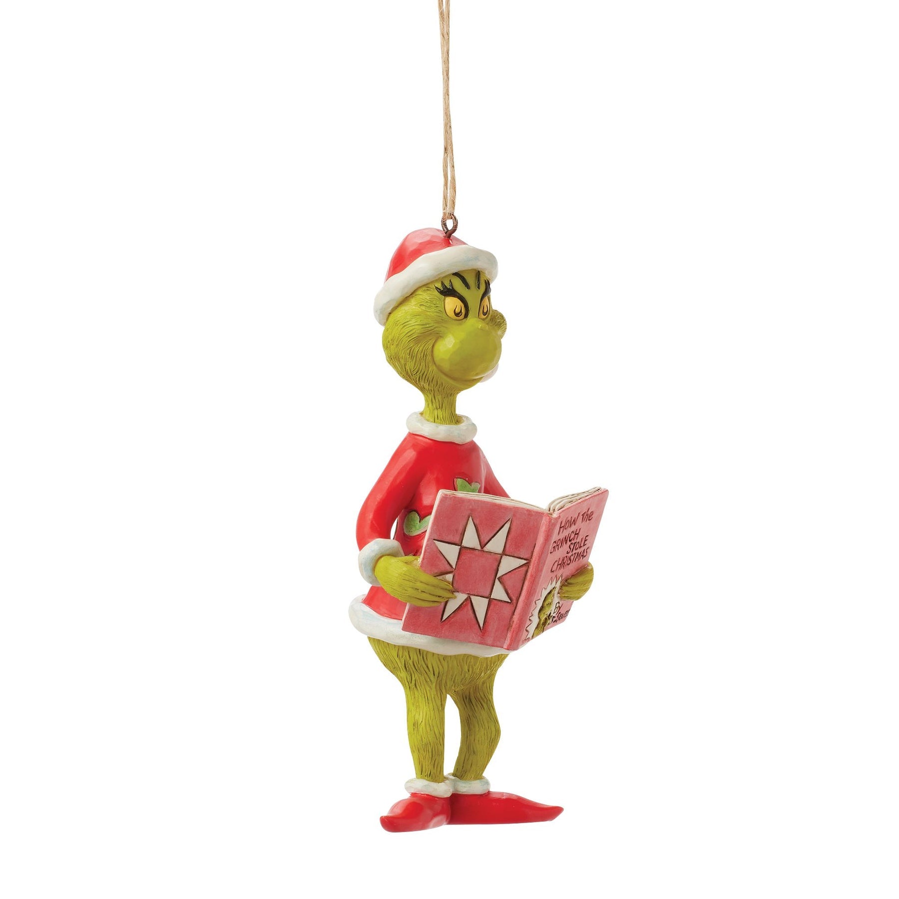 Grinch hanging ornament in Santa hat holding How the Grinch Stole Christmas book, shown at an angle, twine hanger