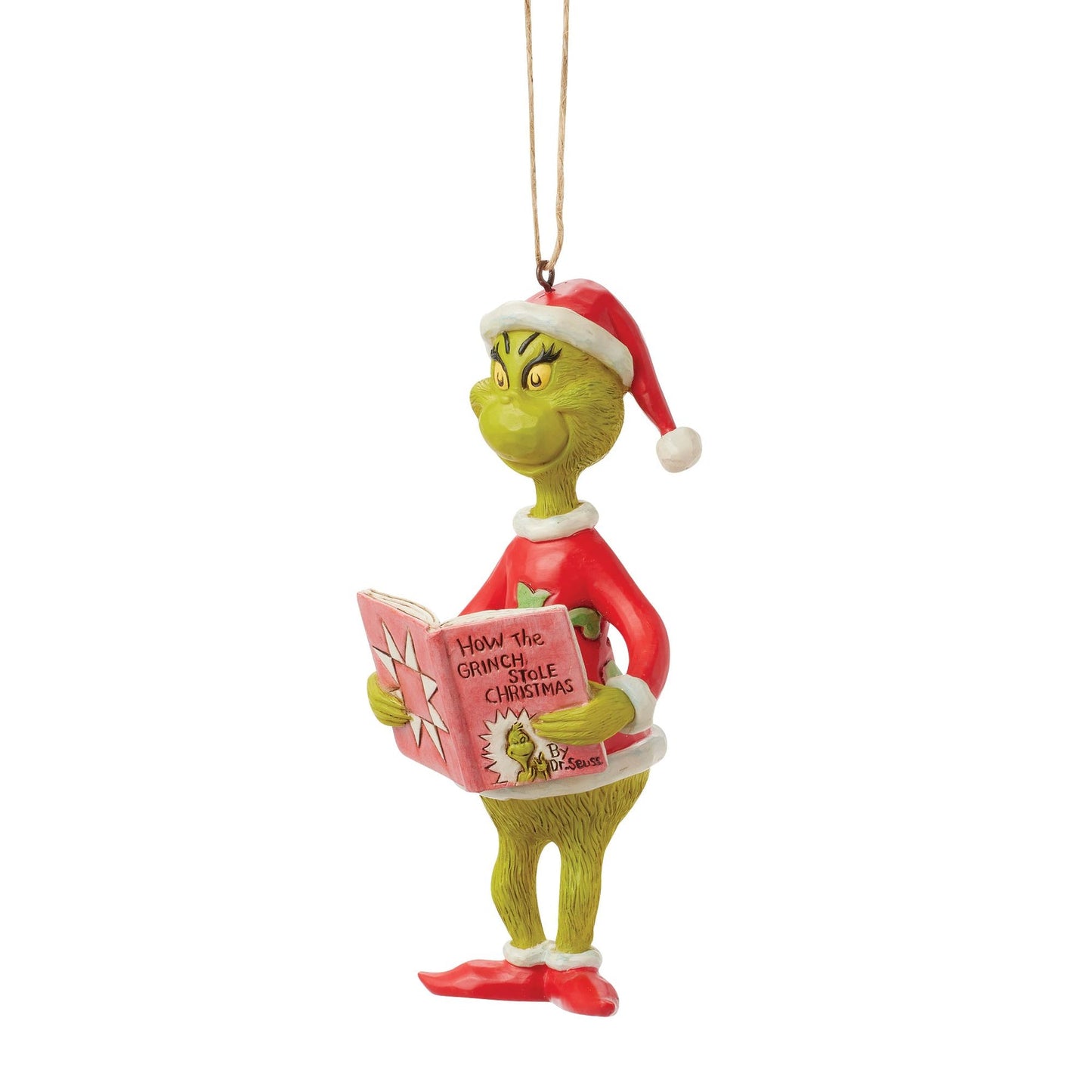 Front view of Grinch hanging ornament in Santa hat, holding open How the Grinch Stole Christmas book, twine hanger