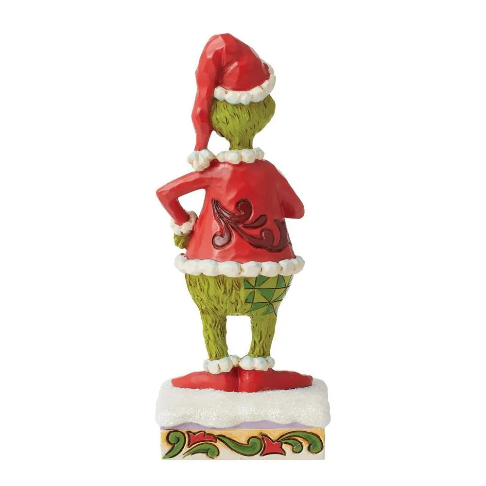 Rear view of Grinch figurine in Santa hat and red scrollwork coat, hands on hips, argyle trousers, scrollwork-decorated base