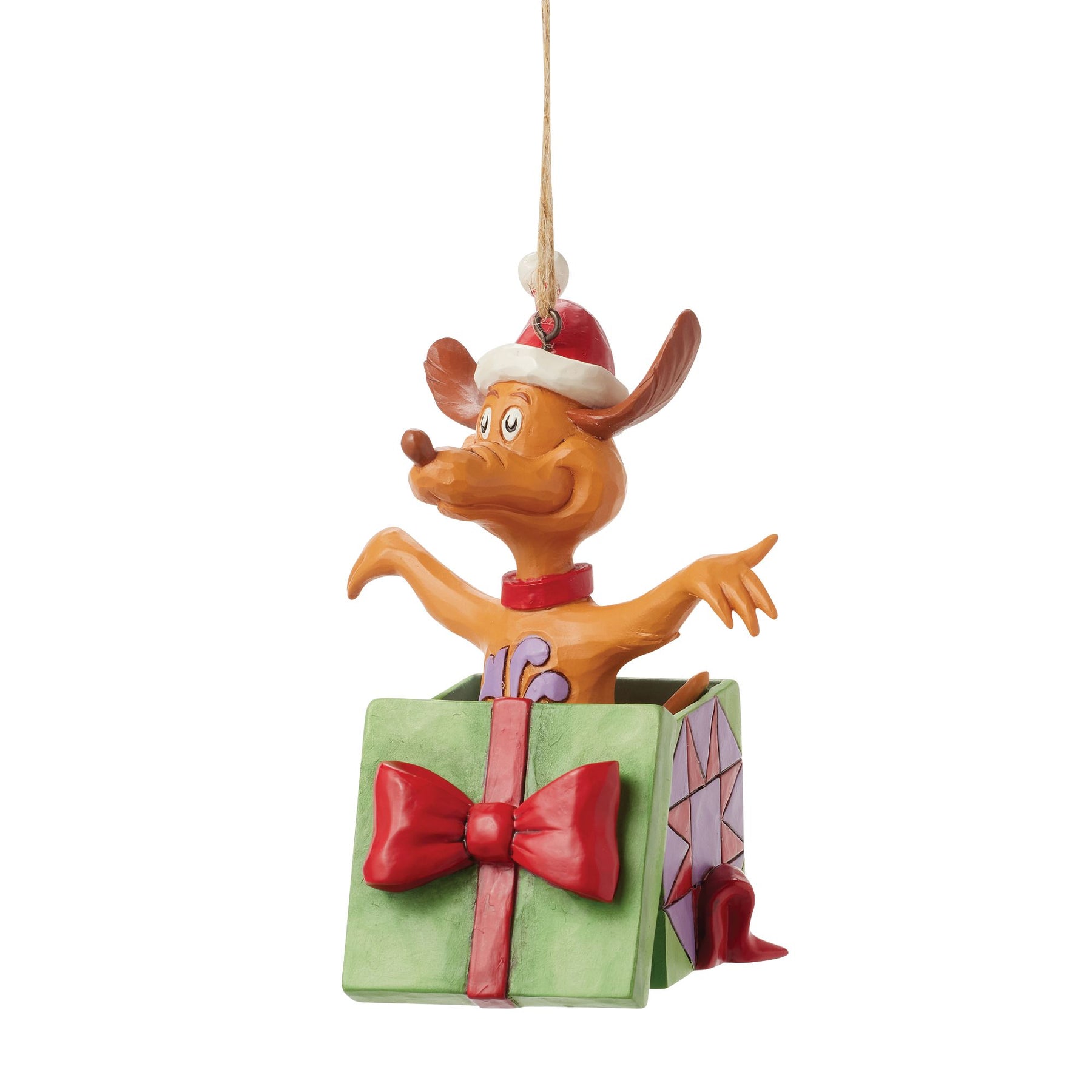 Side view of Max the dog hanging ornament leaping from open green gift box with red bow, Santa hat, twine hanger