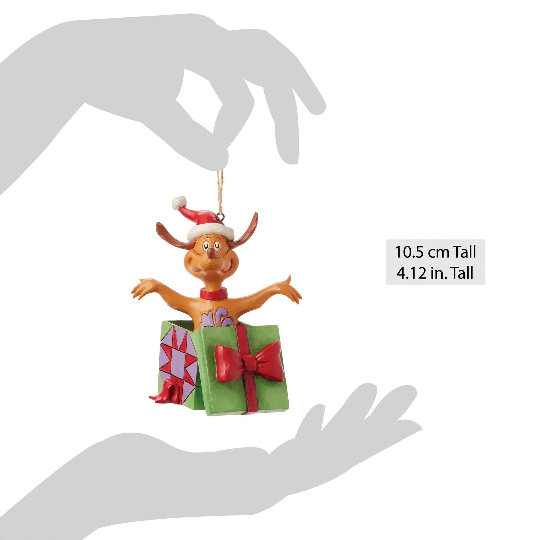 Max the dog ornament shown between two silhouetted hands indicating size of 10.5 cm / 4.12 inches tall
