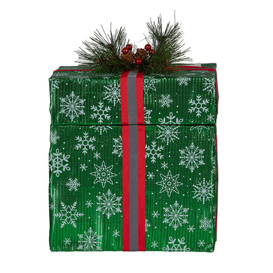 Green snowflake gift box decoration with red ribbon and pine cone berry detail, unlit