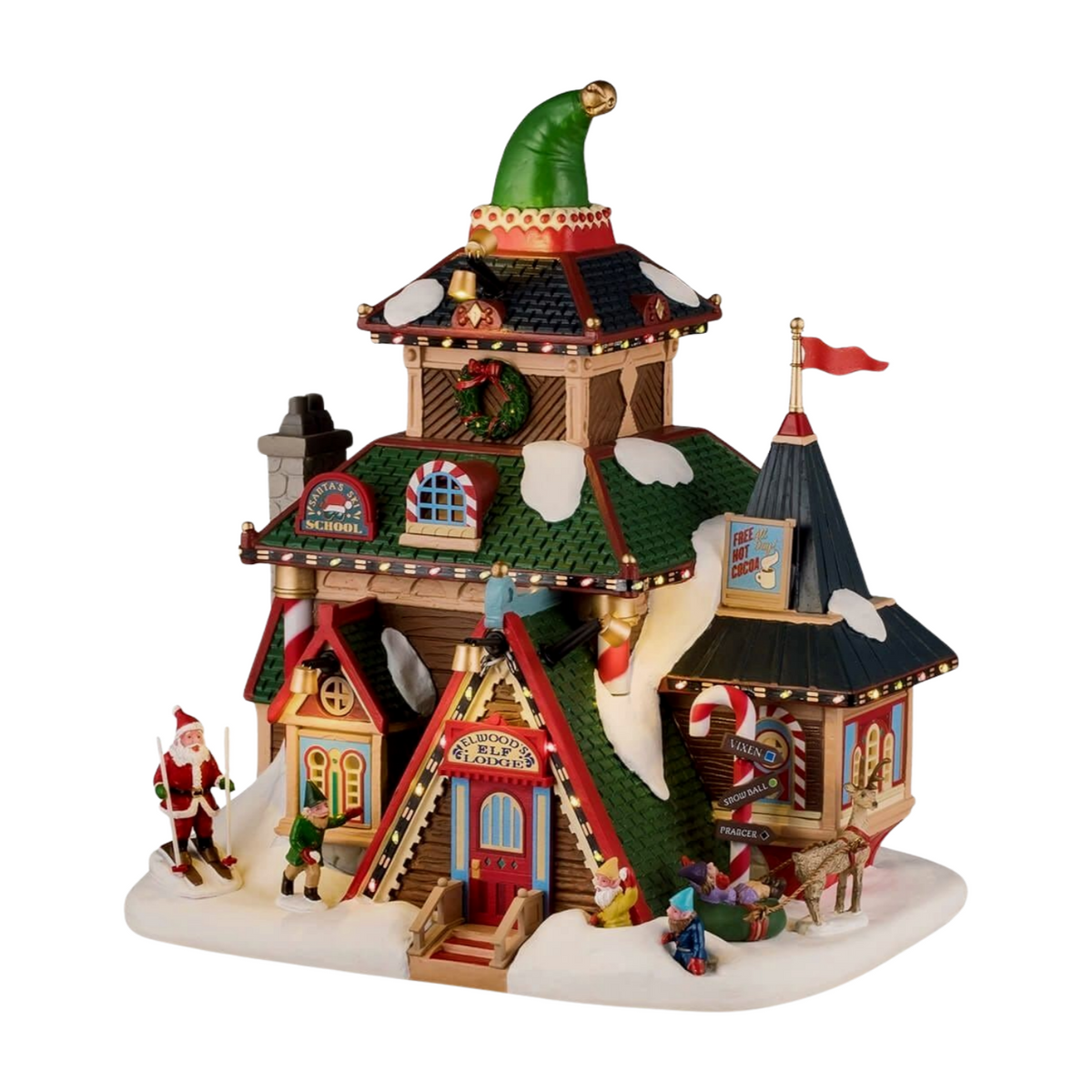 Lit Christmas village building with giant elf hat topper, Santa's Ski School and Elwood's Elf Lodge signs, elves, and Santa figurines
