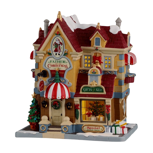 Lemax Christmas Shoppe and Tom's Bookstore village building with nutcracker figures, lit interiors, and festive signage