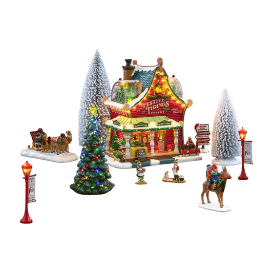 Lemax Festive Tidings Nursery village set with lit building, decorated Christmas trees, elf figures, sleigh, and lamp posts