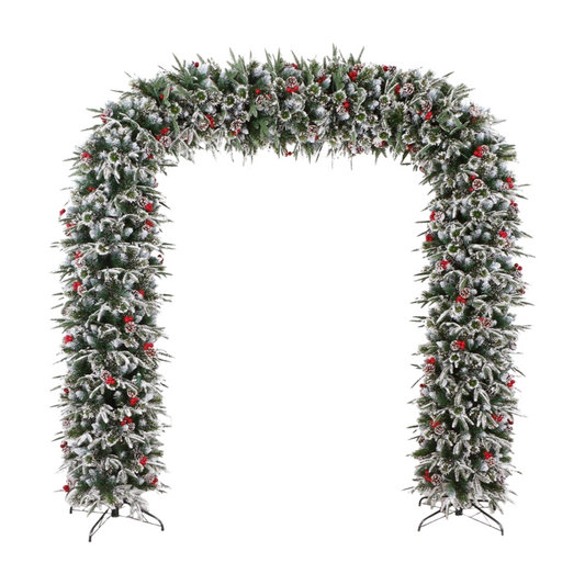Frosted Christmas arch decorated with snow-dusted greenery, red berries, and pinecones