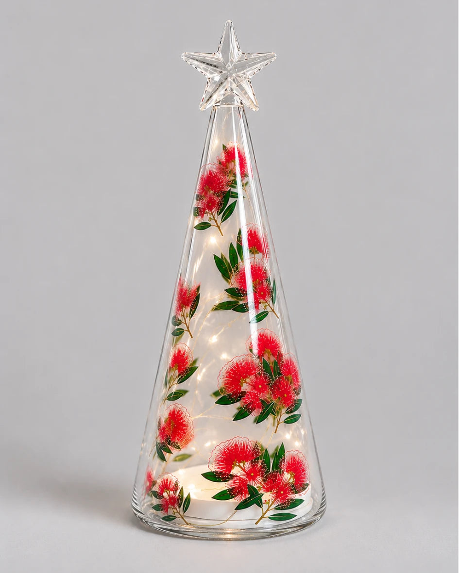 Light-up glass cone with pohutukawa flower print and star topper on plain background