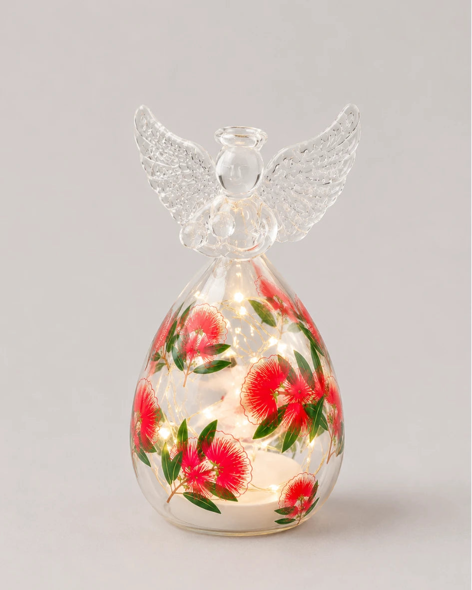 Light-up glass angel figure with pohutukawa flower print and warm LED lights inside