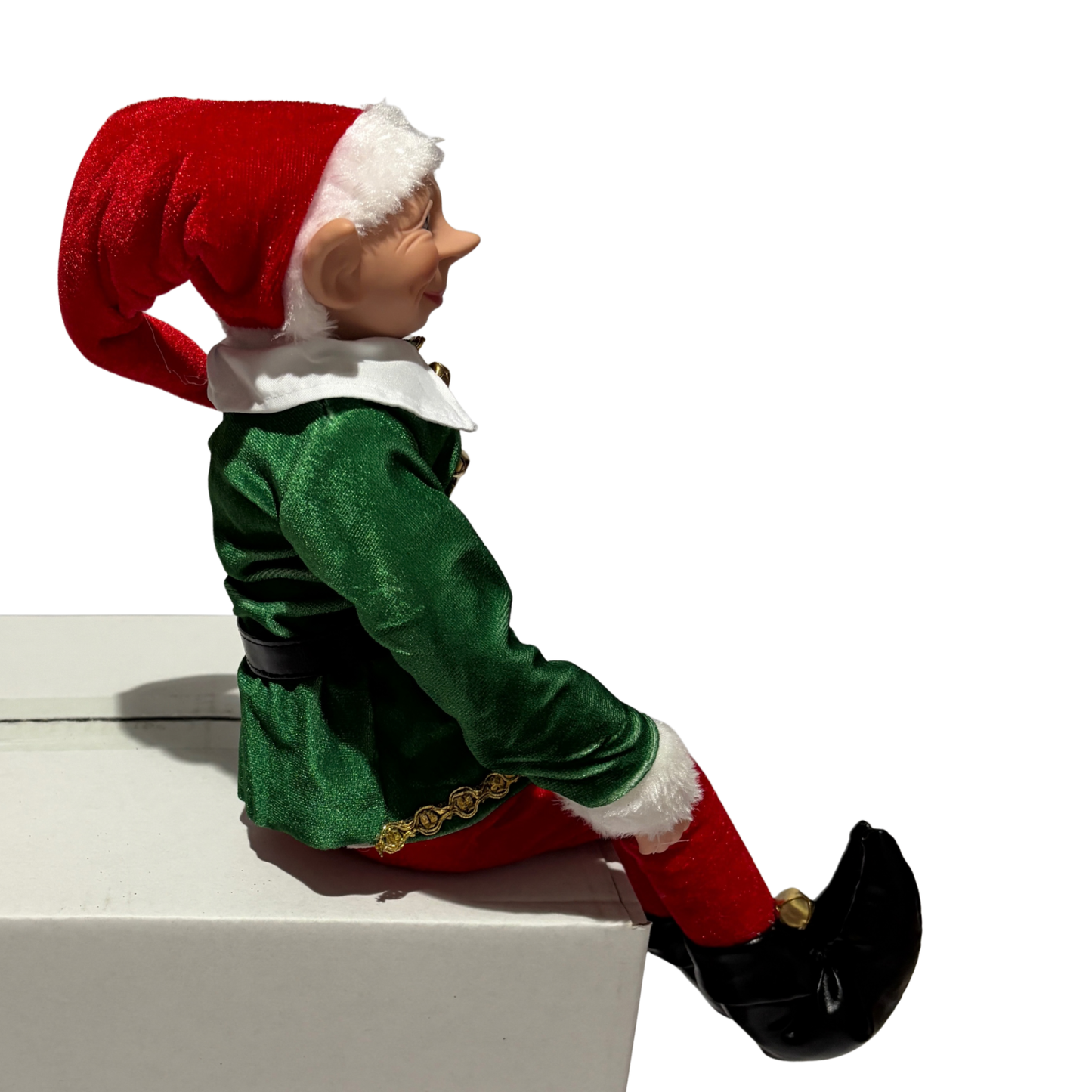 Sitting Christmas elf in green jacket and red trousers with a red hat and black boots