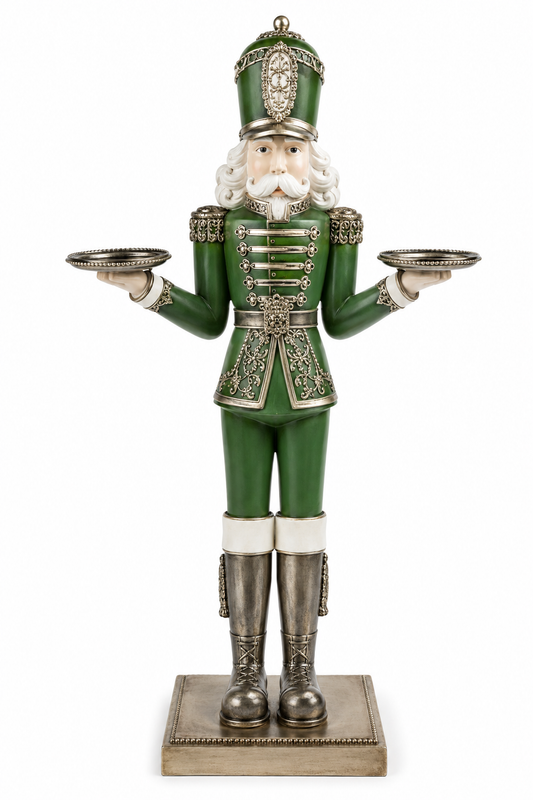 Green and silver nutcracker candle holder figurine with filigree detail holding two silver candle plates
