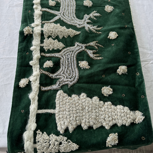 Green velvet table runner with hand-beaded reindeer and embroidered Christmas trees