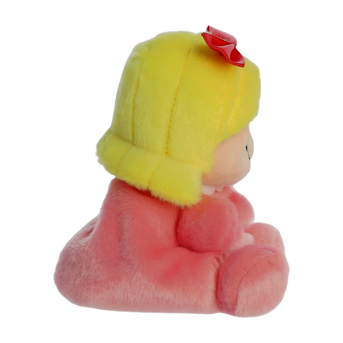 Side view small plush doll with blonde hair, red bow, pink outfit, and embroidered smiling face inspired by Cindy Lou from the Grinch