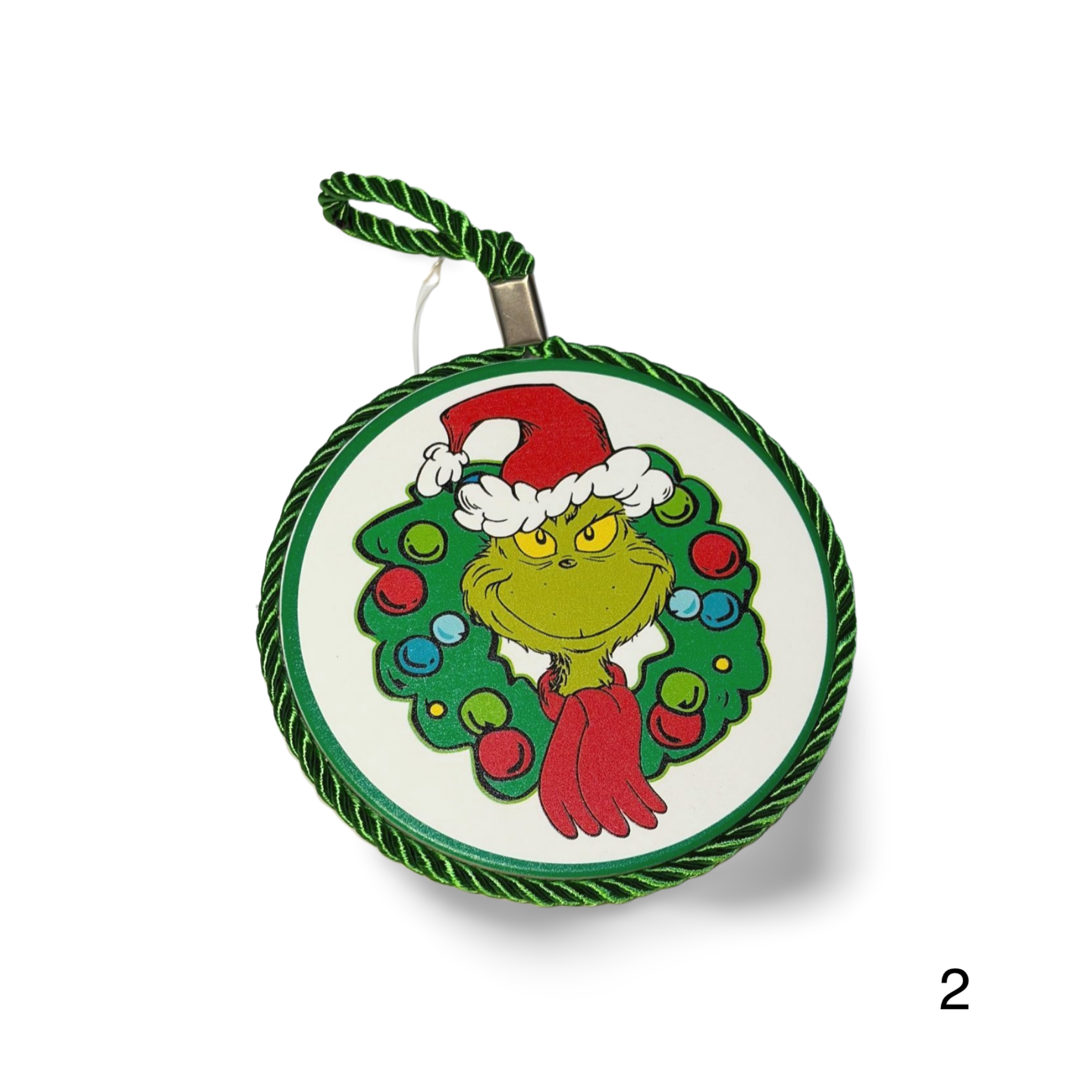 Christmas ornament with a green face, red suit, and Santa hat on a white background