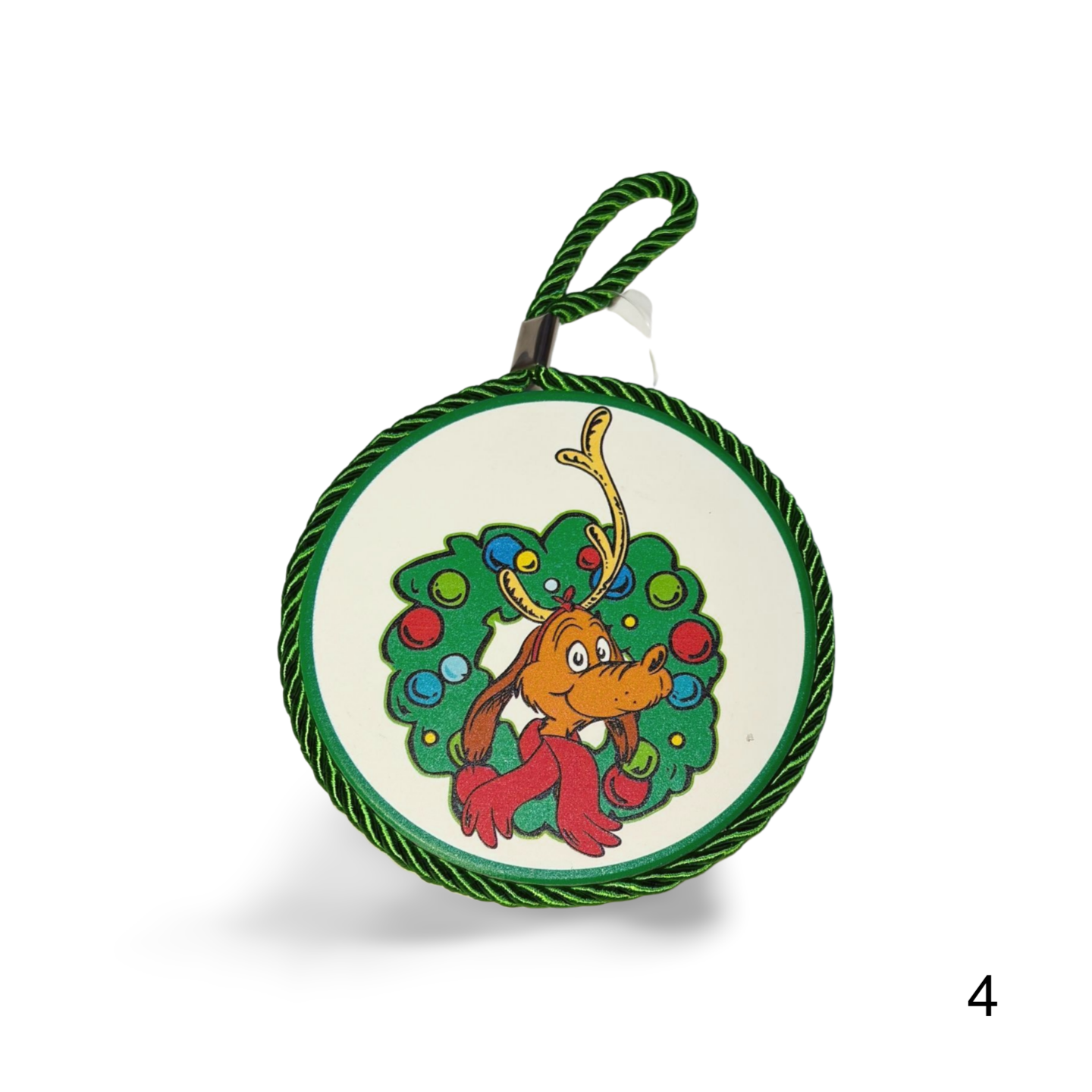 Circular Christmas ornament with a cartoon reindeer and wreath design on a white background.