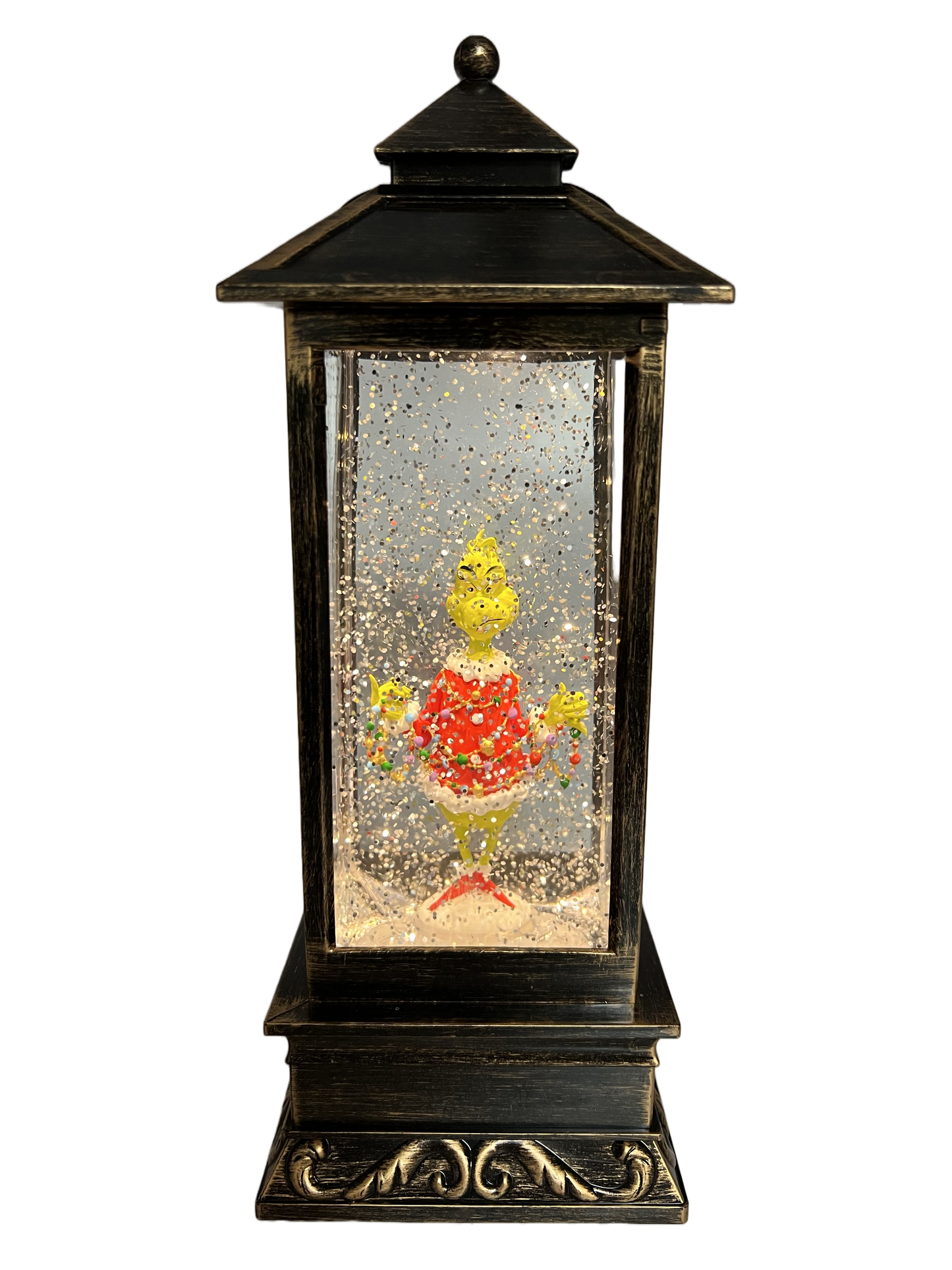 Brass lantern-style snow globe featuring the Grinch in a red Santa outfit surrounded by swirling glitter