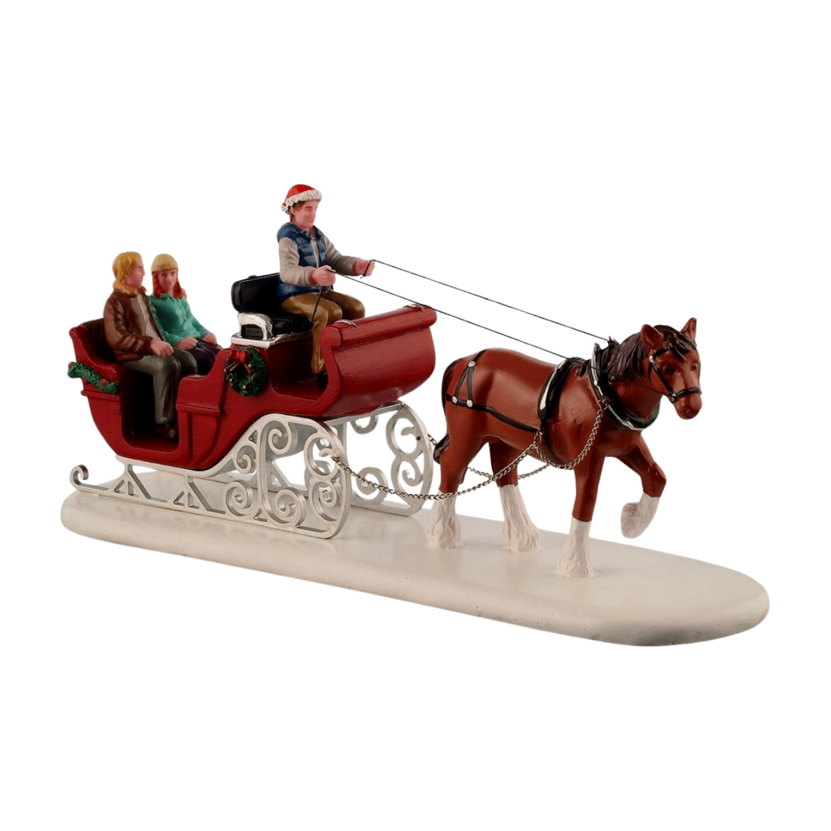 Christmas village figurine of a horse-drawn red sleigh with a driver in a Santa hat and two seated passengers, on a snowy white base 